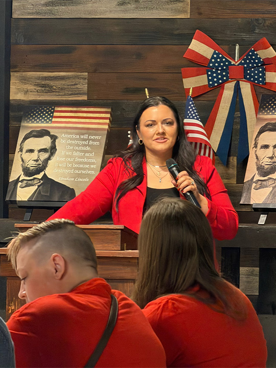 Carissa Bryant speaking at a podium